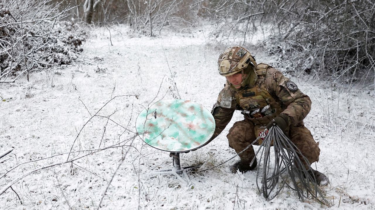 A Ukrainian soldier disconnects their Starlink on the front line during a ceasefire announced by Russia over the Orthodox Christmas period, January 6, 2023.
